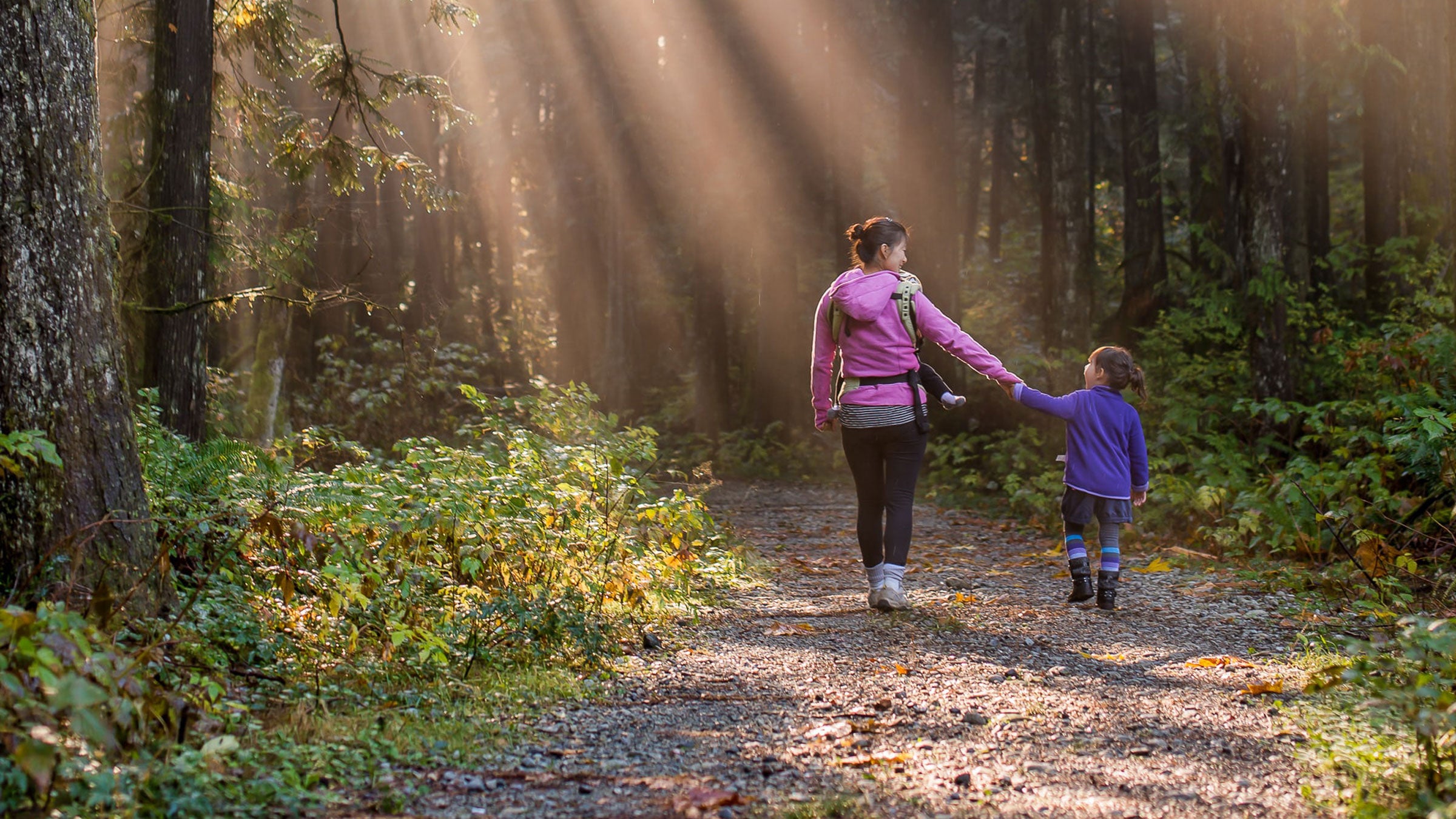 Mom and daughter walking in the woods