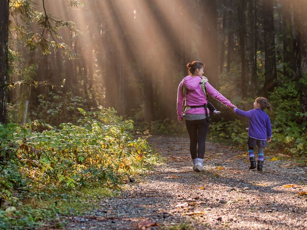 Mom and daughter walking in the woods