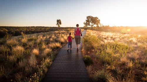 Mom and daughter walking down nature trail