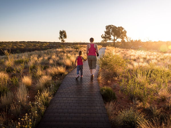 Mom and daughter walking down nature trail