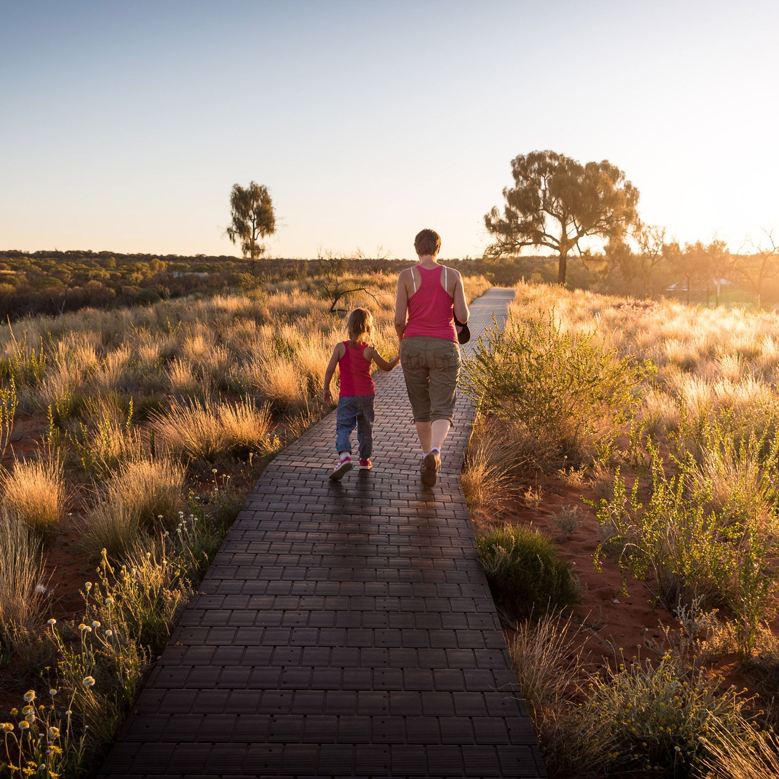 Mom and daughter walking along a nature trail