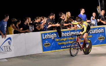 The author giving high fives to friends watching from the rail after winning a Keirin event at the Valley Preferred Cycling Center in 2017