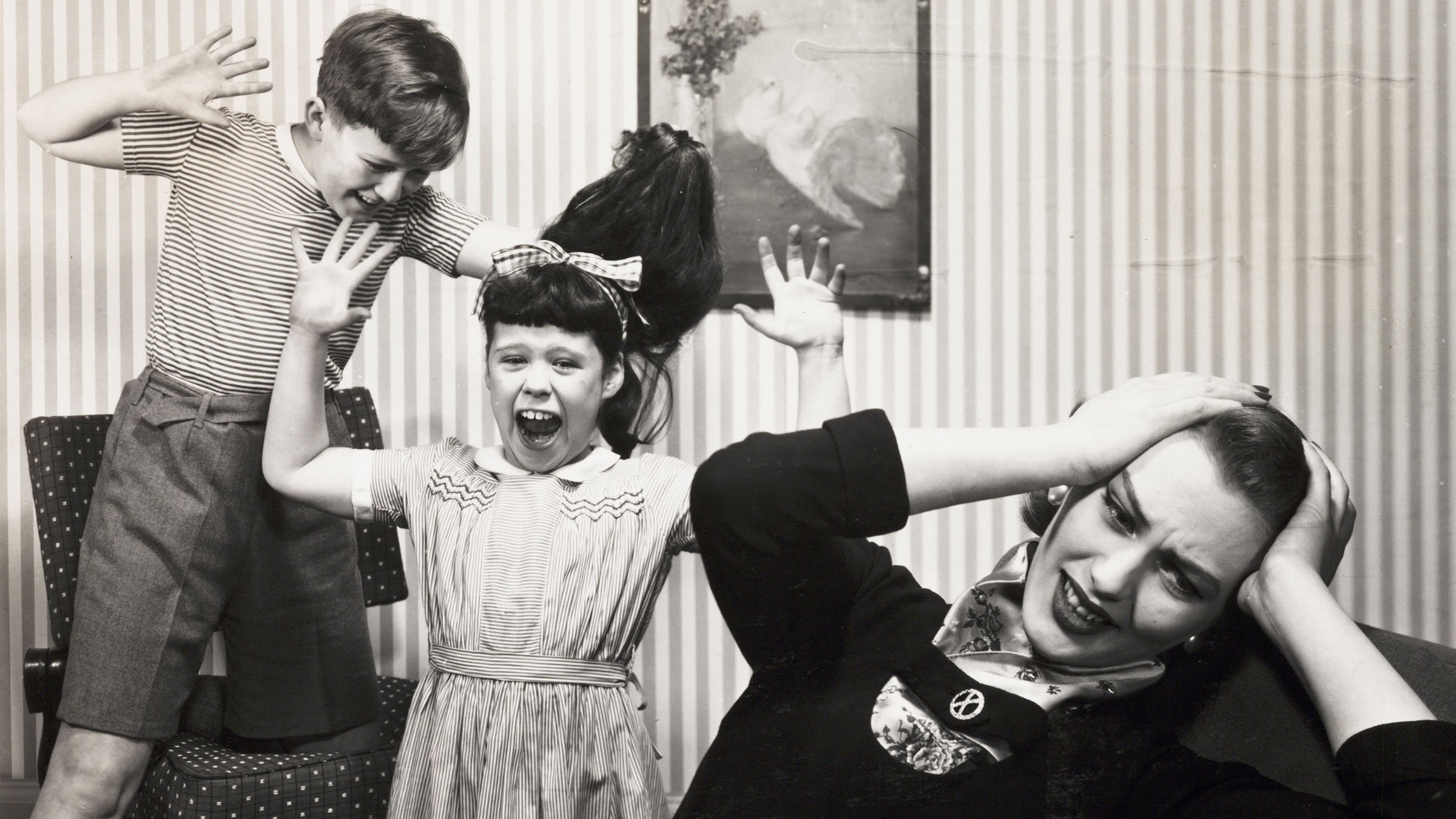 Mother and two fighting children, c 1958.