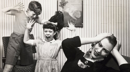 Mother and two fighting children, c 1958.