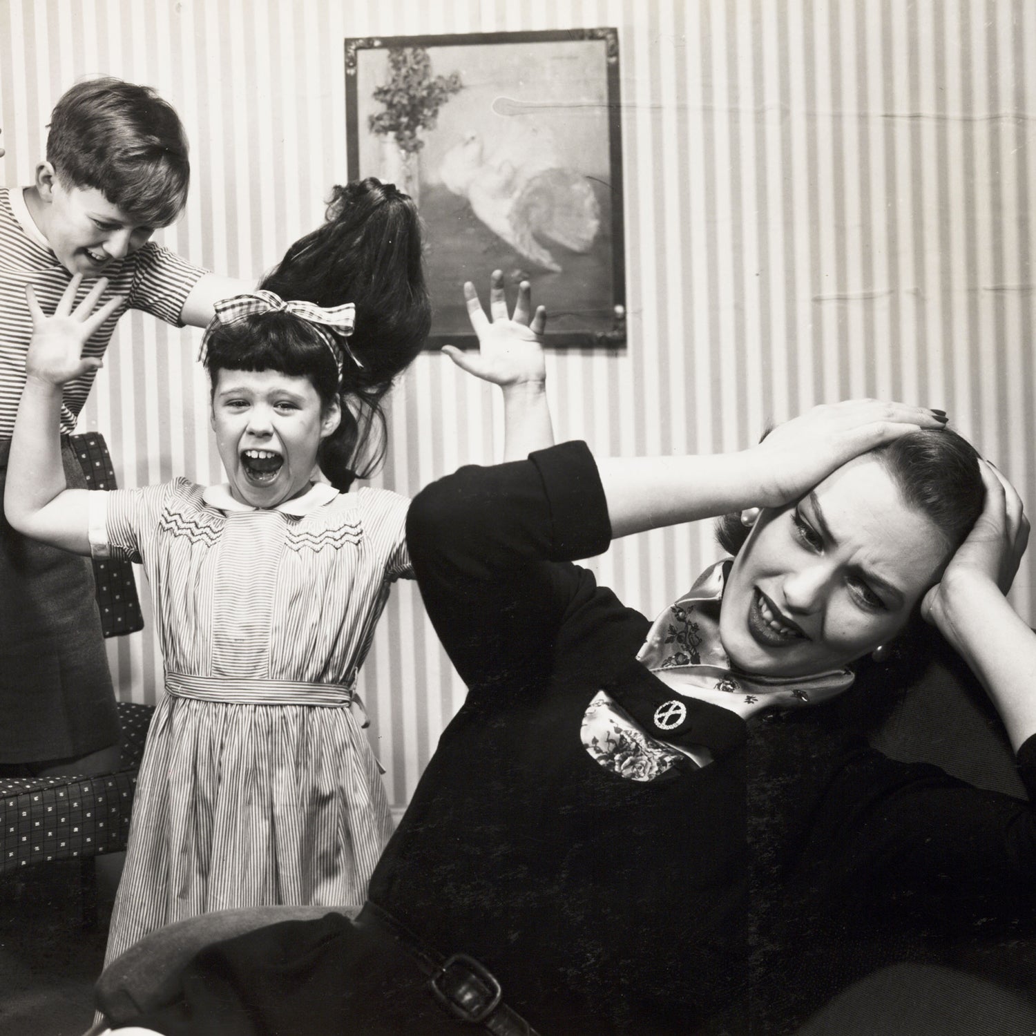 Mother and two fighting children, c 1958.