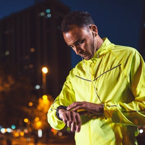 Handsome Athlete In Yellow Checking Time