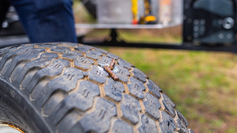 The plug should remain in the tire when you yank the tool out. Now just trim off that excess length.