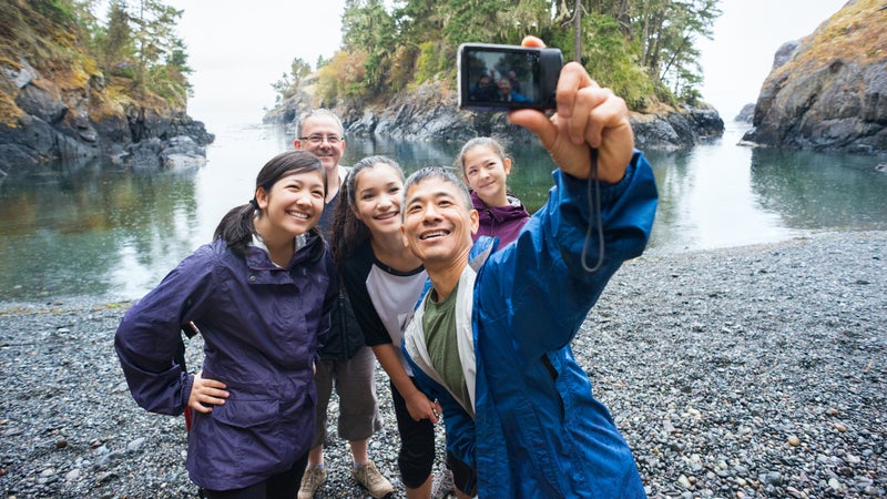 Multi-Ethnic Hiking Family Posing for Selfie on Remote Wilderness Beach