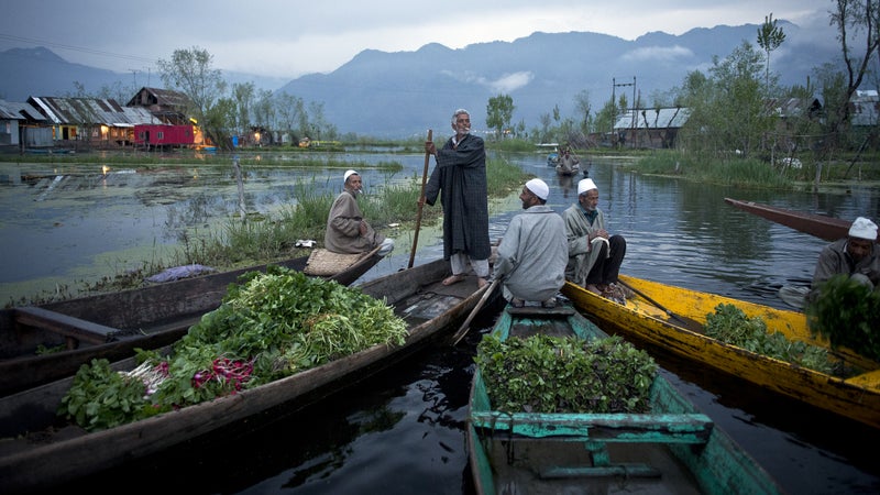 Kashmiri men sell their vegetables at a floating market on the picturesque Dal Lake in the summer capital of Srinagar, in the Indian-held state of Kashmir. Once a tourist hot spot, the only visitors to this magnificent landscape these days are Indian soldiers.