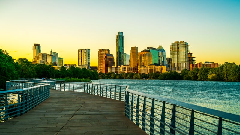 Austin Texas golden sunset at pedestrian bridge urban modern skyline cityscape at Lady Bird Lake