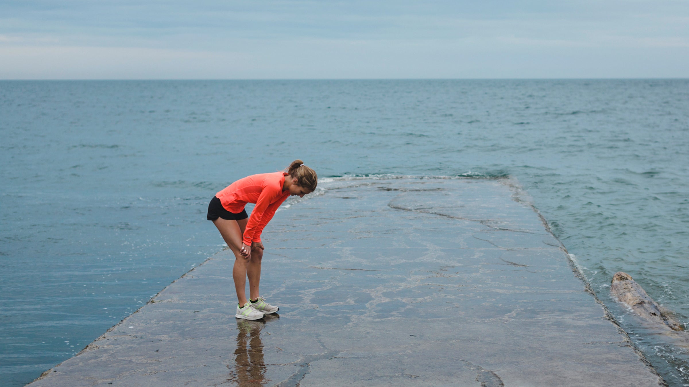 Motivated Young Runner Woman Breathing Hard Outside On Cold Windy Day