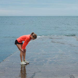 Motivated Young Runner Woman Breathing Hard Outside On Cold Windy Day