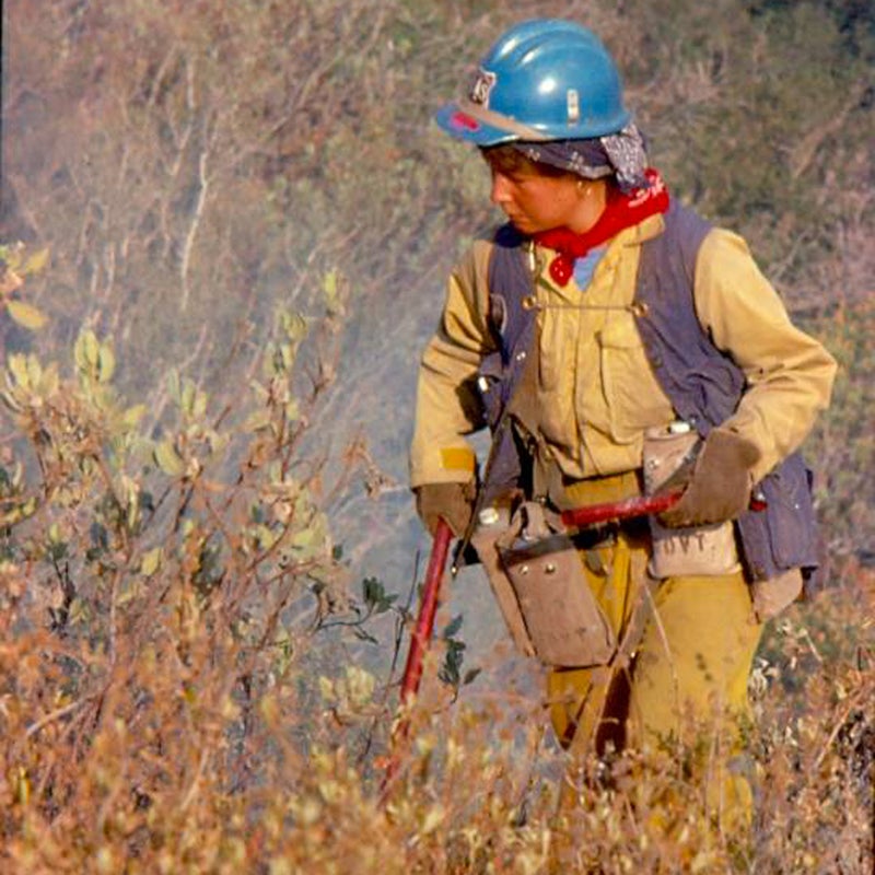 Sue Husari lights brush during a burnout operation in California in 1977.