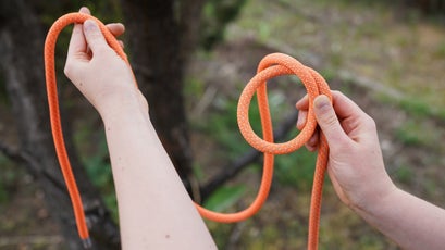 Safety, Prevention and Hiking Rope Knot in a Bowline Against a Wooden  Background, Ready To Be Used in an Adventure or Stock Photo - Image of  measure, wood: 262811180