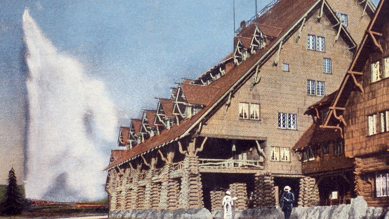 On old postcard of the Old Faithfull Inn. You can still stay here.