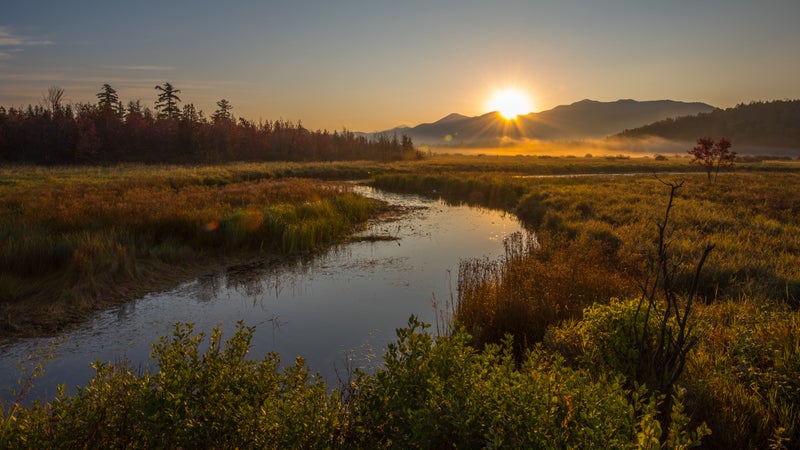 Sunrise over McKenzie Mountain as seen from the Saranac River in Saranac Lake, New York, the Adirondacks