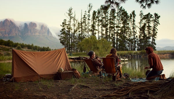 Young friends camping by lake