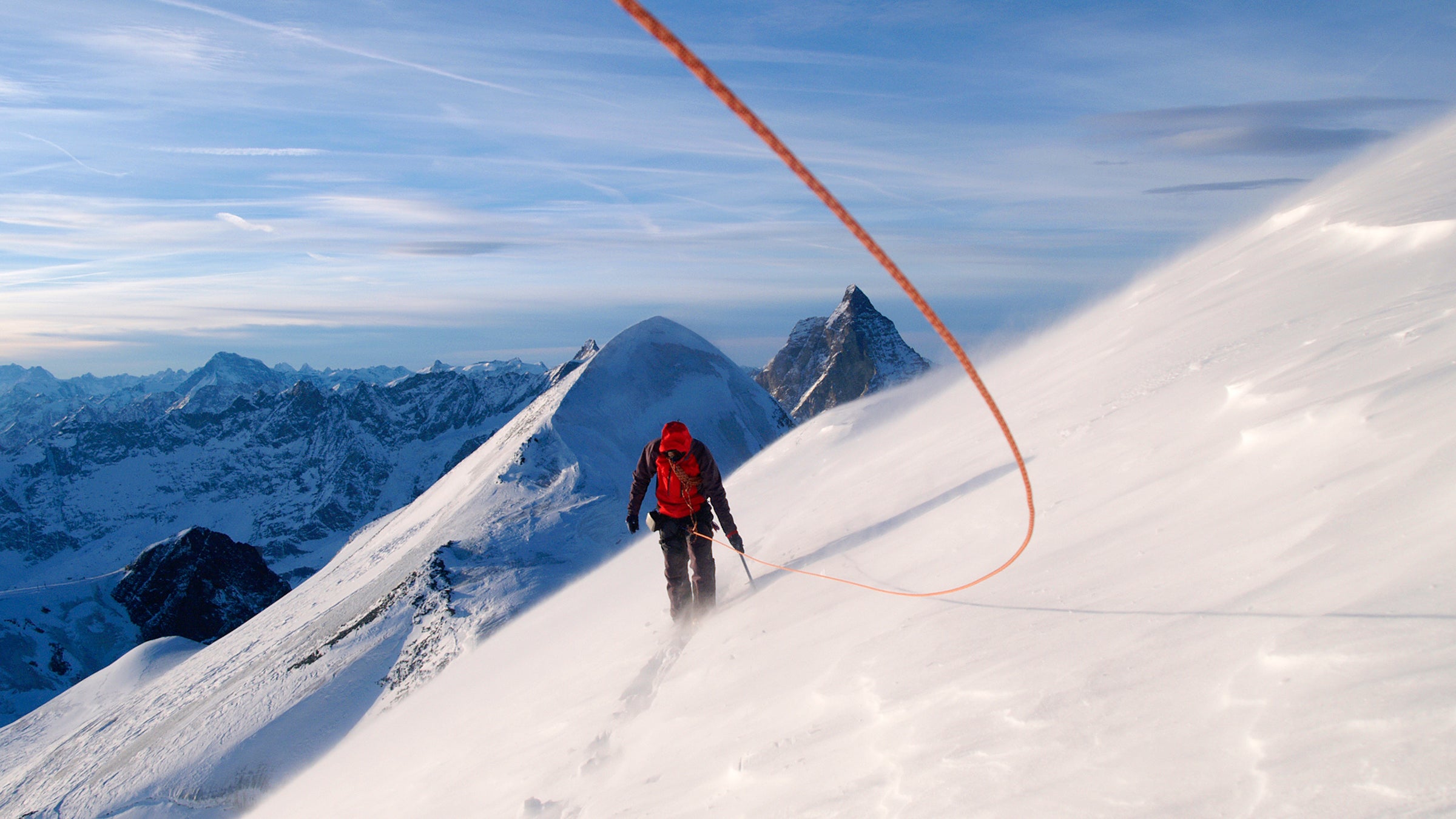 A mountain climber is climbing.