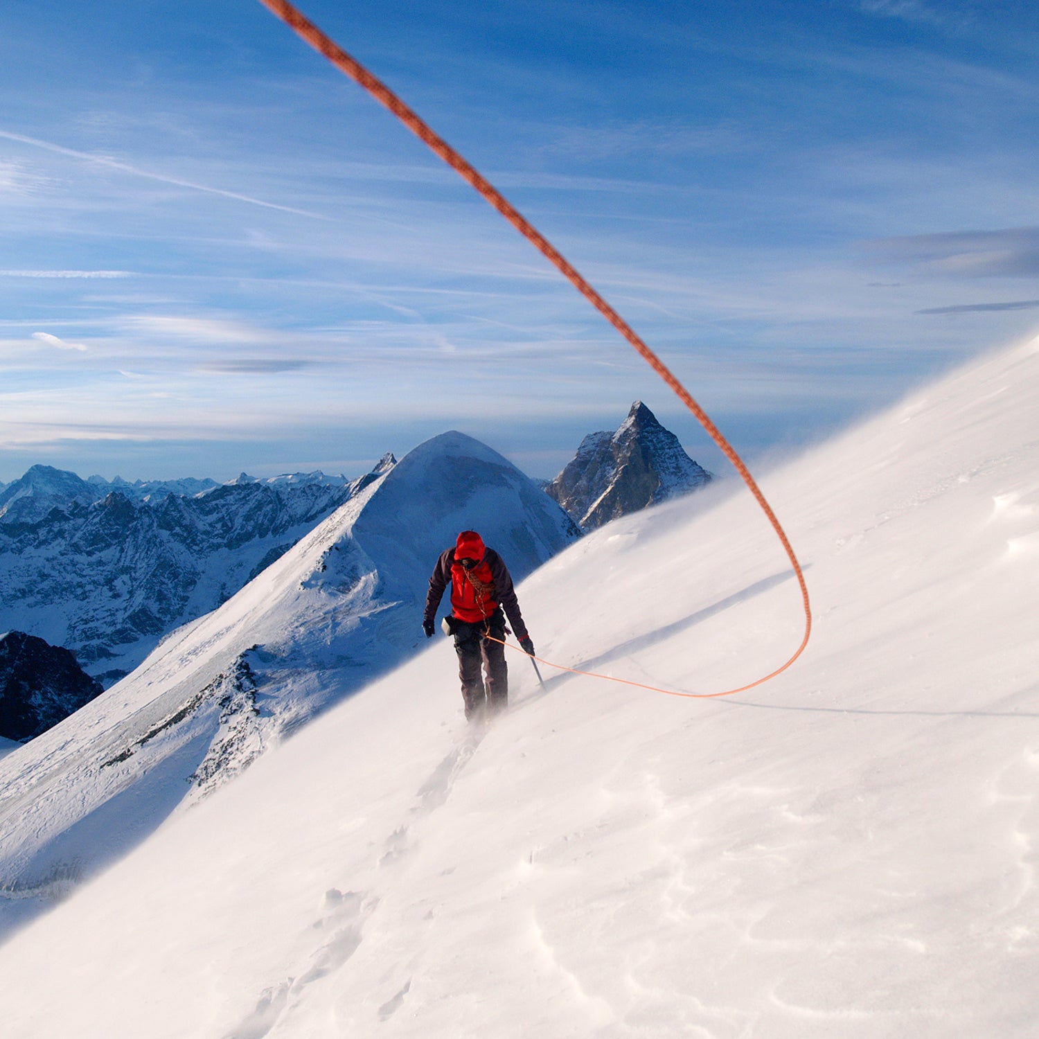 A mountain climber is climbing.