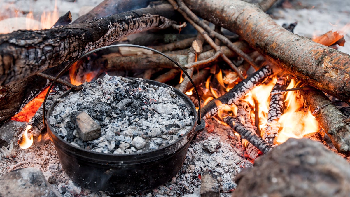 Two Large Iron Pots Cooking Over A Wood Fire For A Meal In The