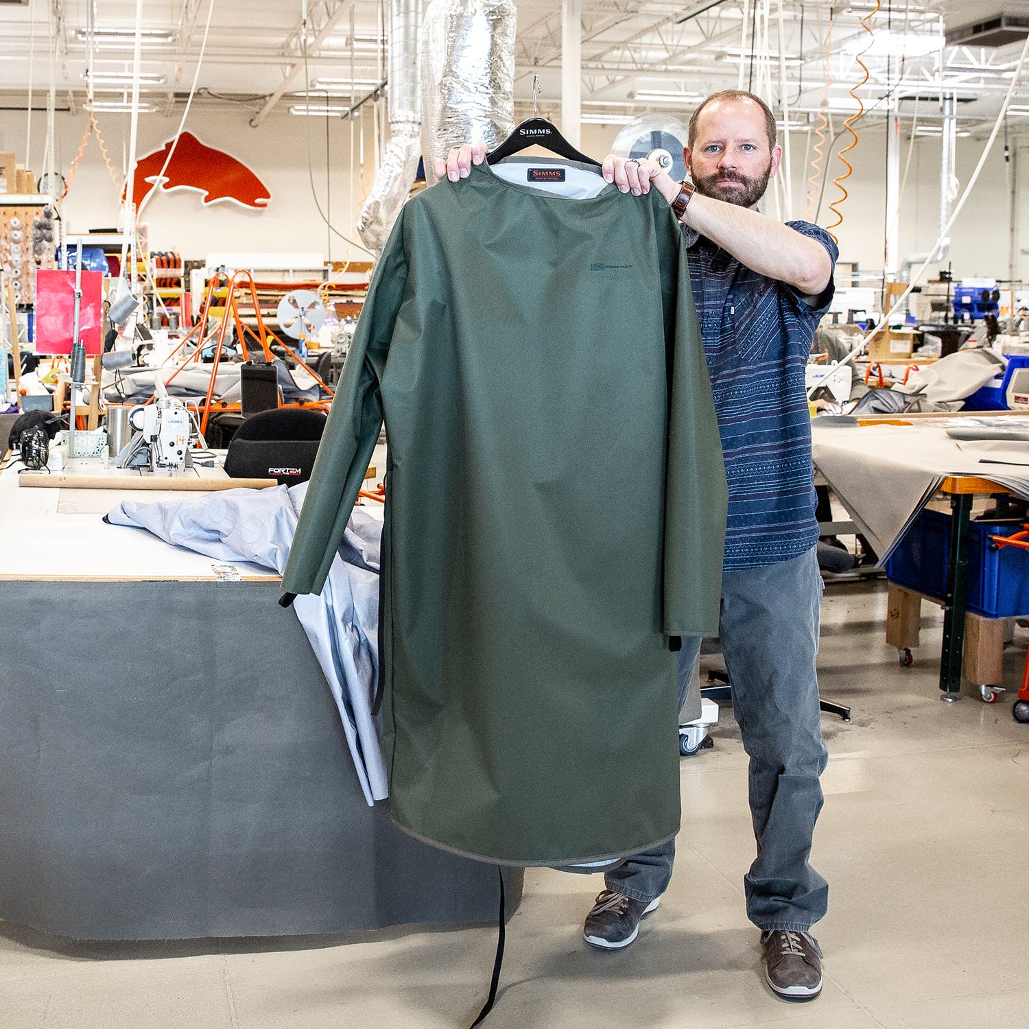 man holding a protective gown