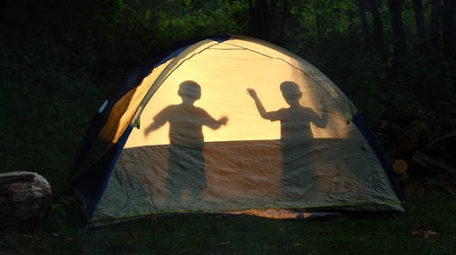 Children silhouetted in tent