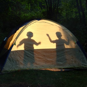 Children silhouetted in tent