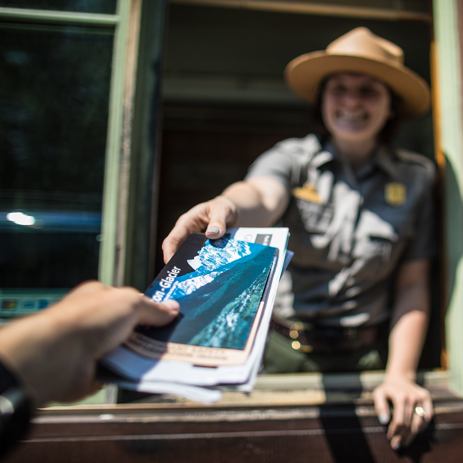 A ranger greets a visitor at Glacier National Park in 2018.