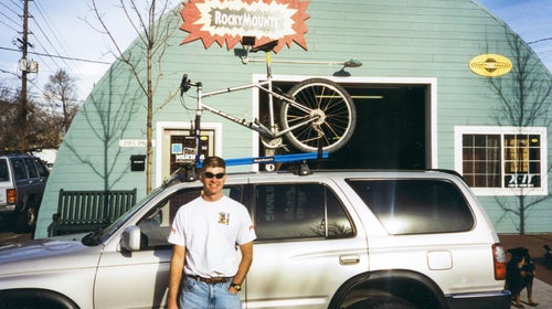 Bobby Noyes in front of RockyMounts’ first home, on Spruce Street in Boulder, Colorado, in 1995