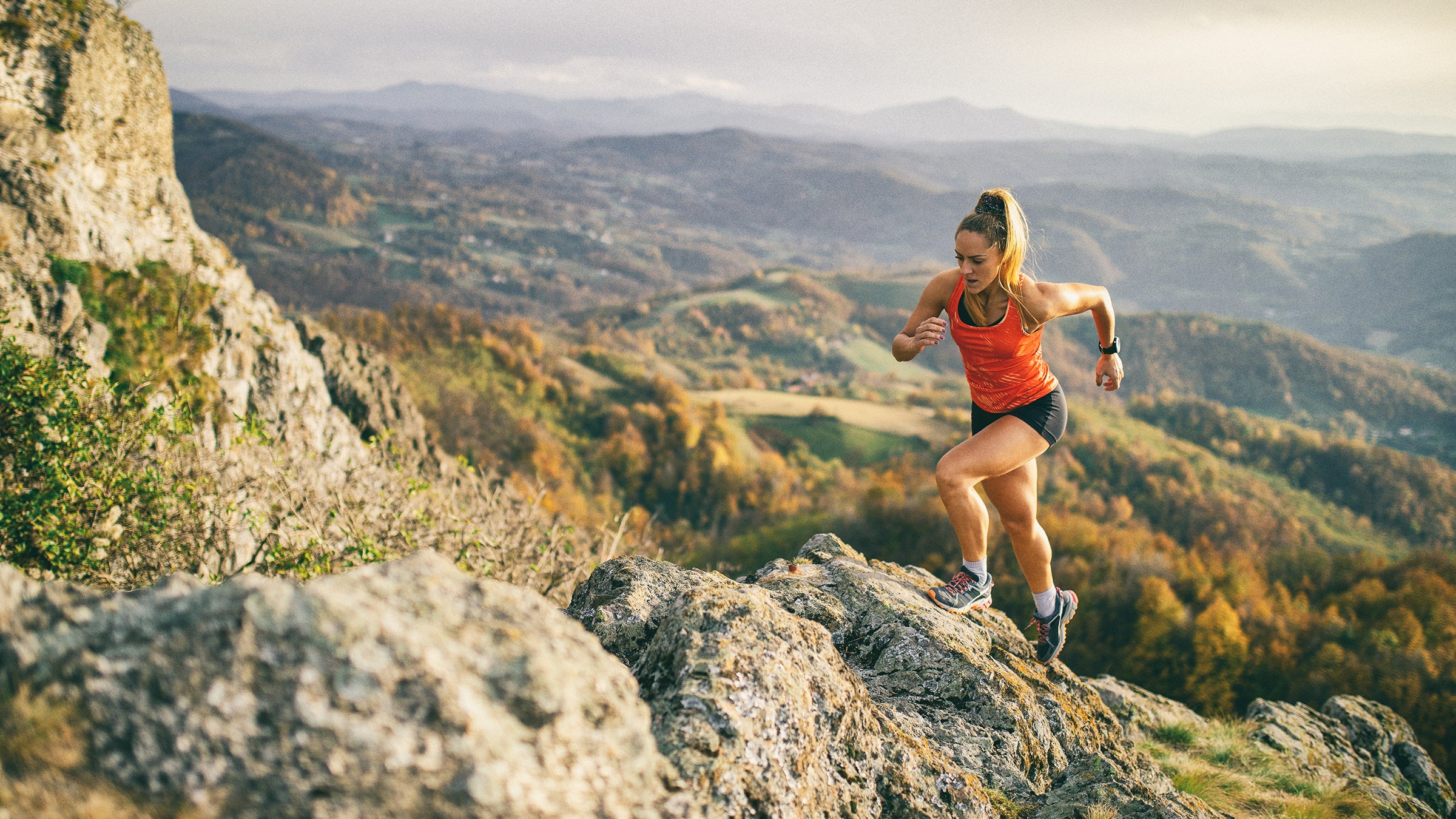 Young woman running on mountain