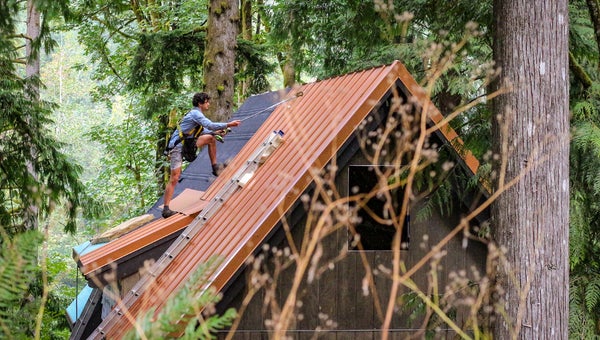 Bryan Schatz on top of the cabin he built with Patrick (Pat) Hutchison in Washington’s Cascade Mountains in 2018