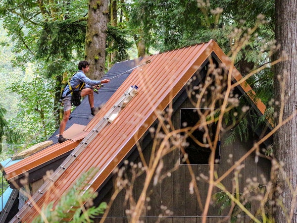 Bryan Schatz on top of the cabin he built with Patrick (Pat) Hutchison in Washington’s Cascade Mountains in 2018