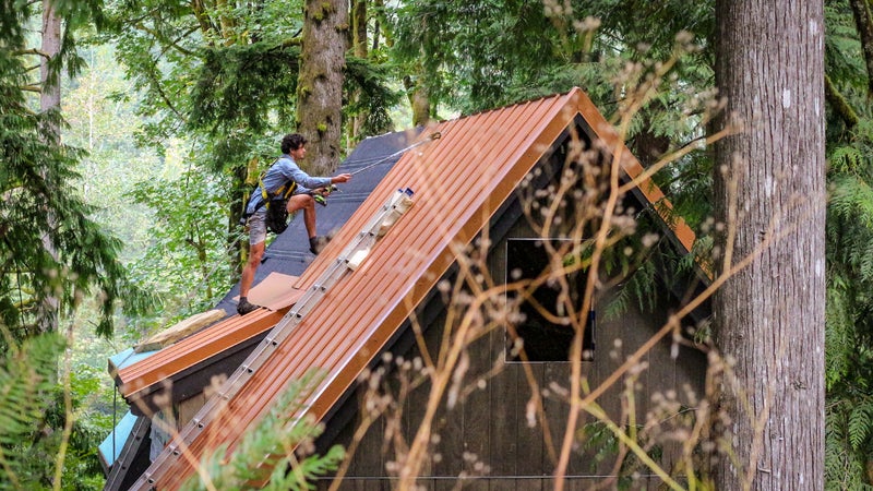 Bryan Schatz on top of the cabin he built with Patrick (Pat) Hutchison in Washington’s Cascade Mountains in 2018