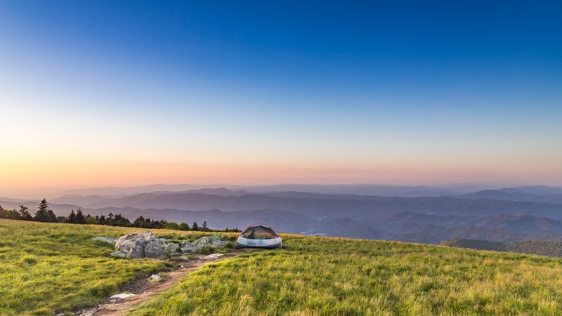 Camping on mountaintop at sunset