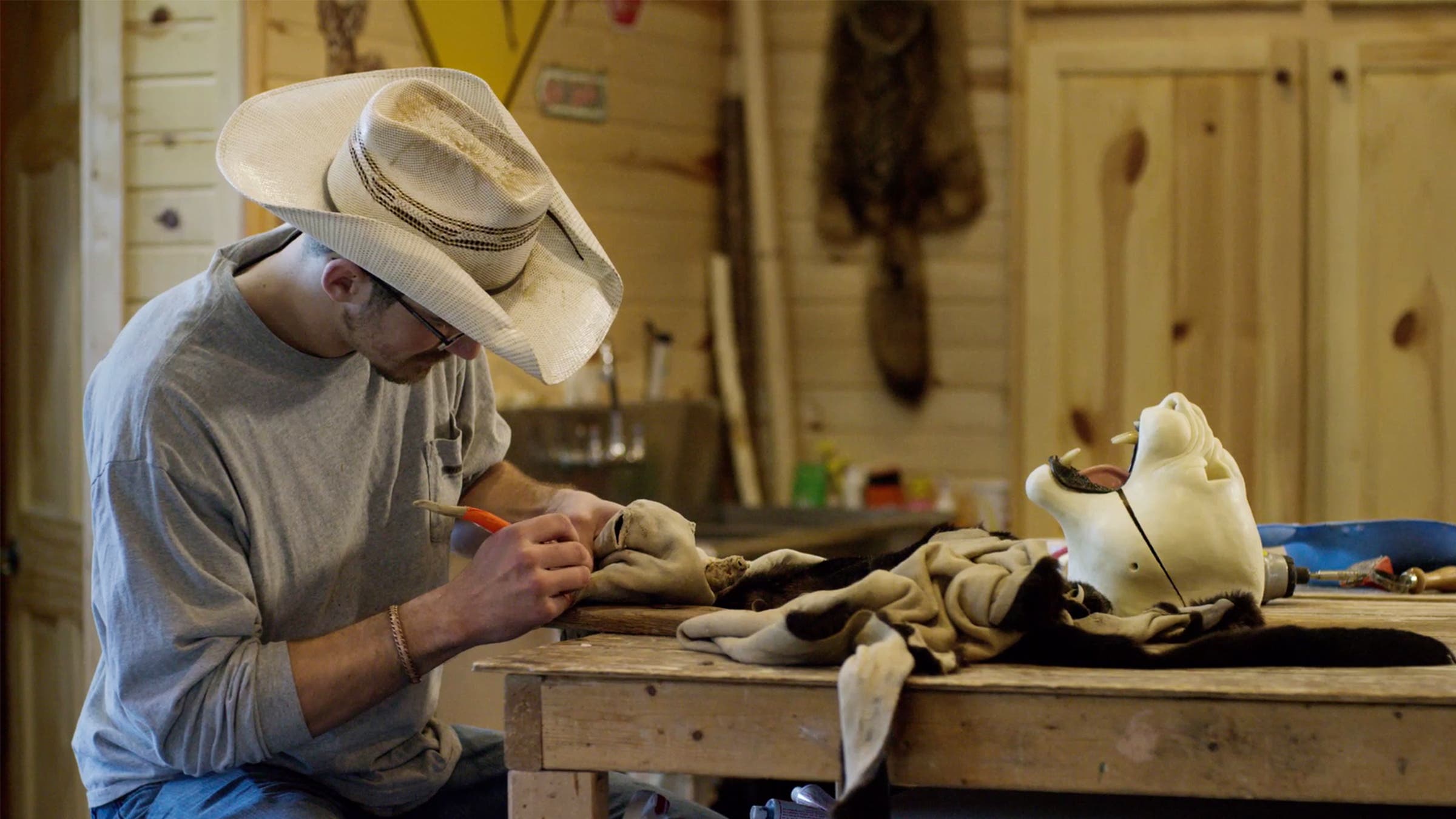 Daniel Meng working on a black leopard hide