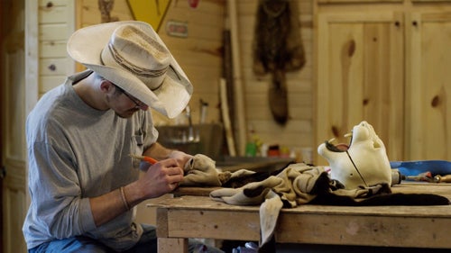 Daniel Meng working on a black leopard hide