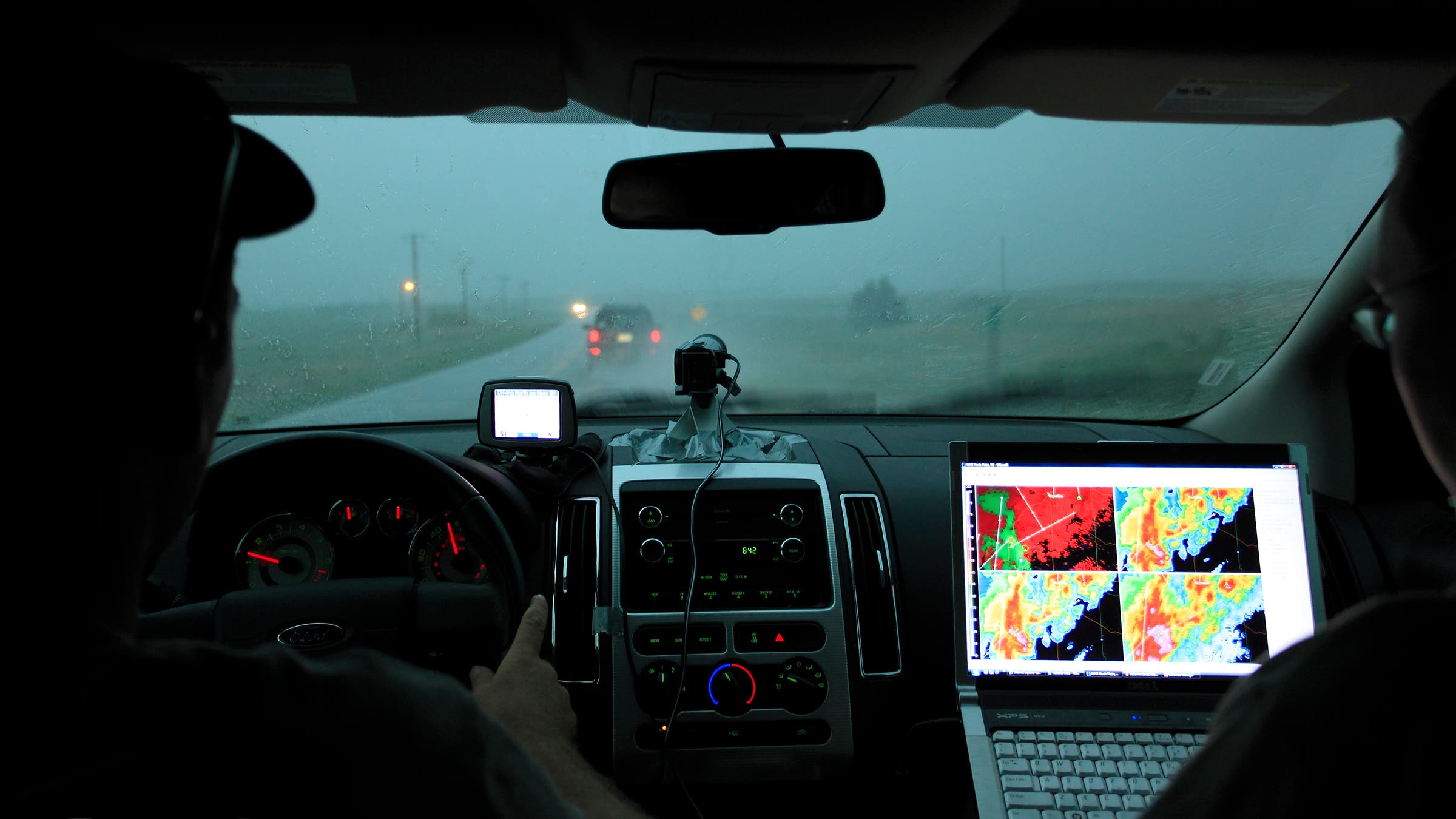 Storm chasers with computer technology in motor vehicle