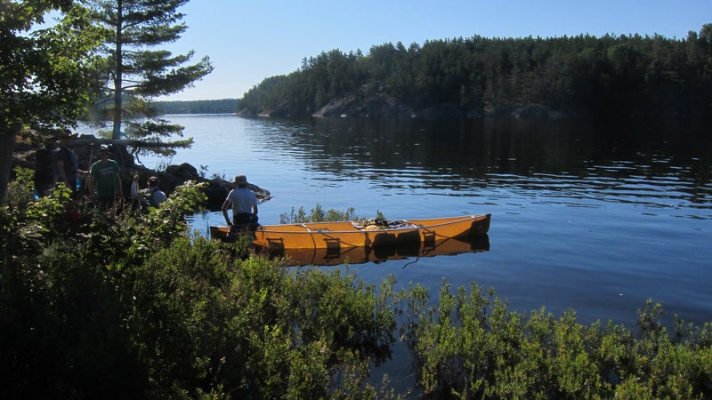 This is Souris River’s Quetico 18.5. It easily fits two 100-liter packs behind the front paddler.