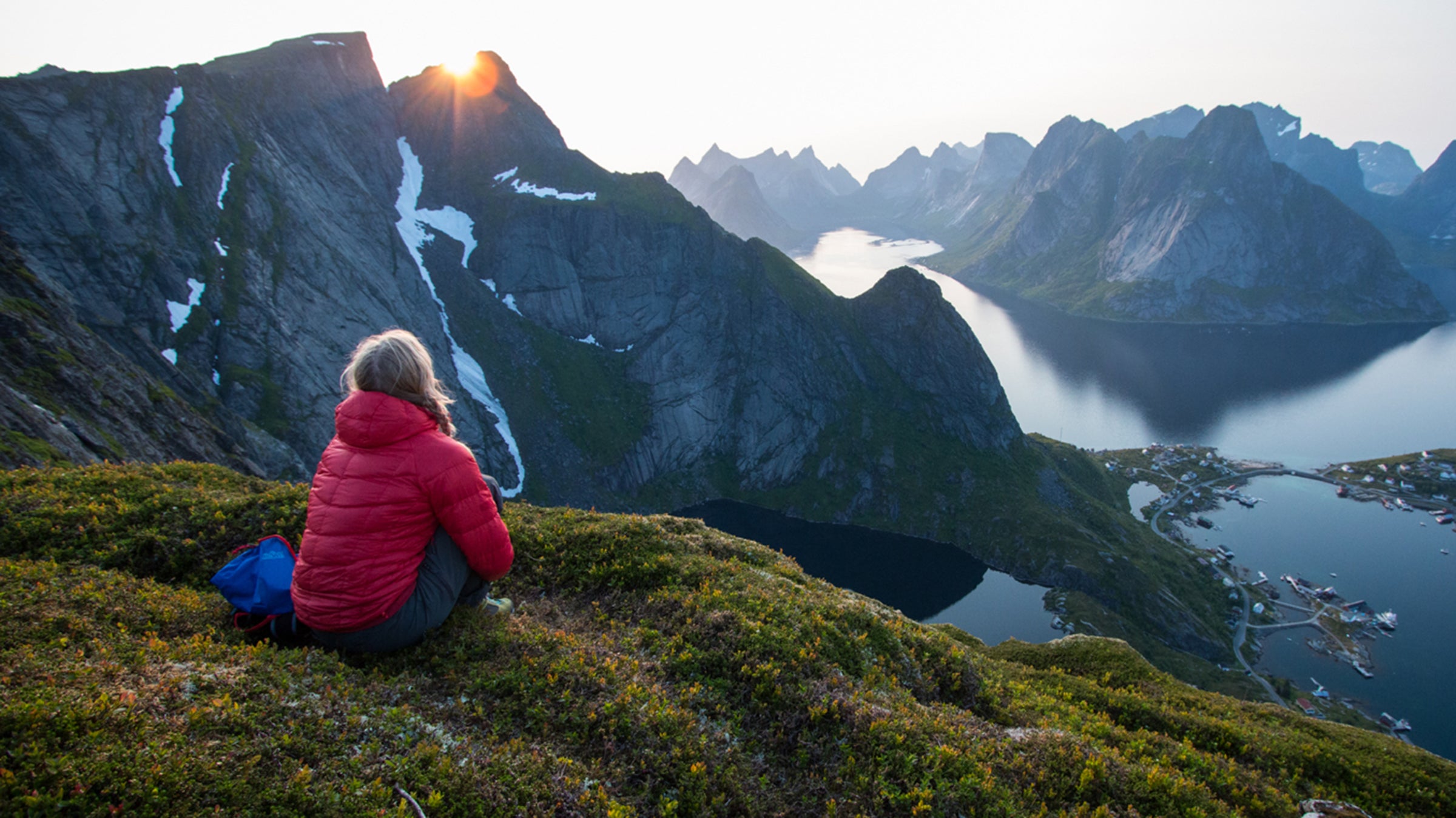 Hilary Oliver looks out over the fjords and peaks near Reine, Norway, from the top of Reinebringen.