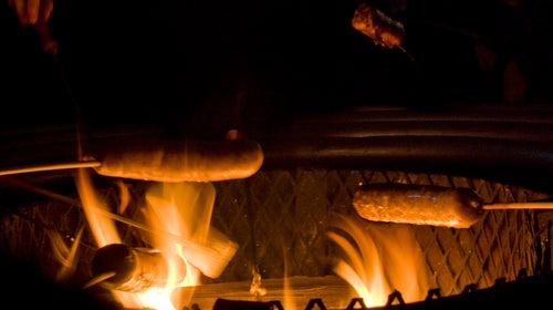 Sausages over a campfire