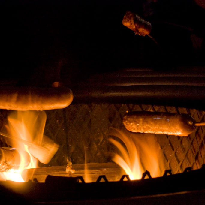 Sausages over a campfire