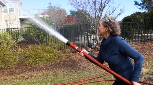 Kathryn demonstrating how she wet down her home