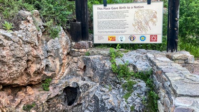 Wind Cave’s natural entrance and a sign explaining its significance to the Lakota
