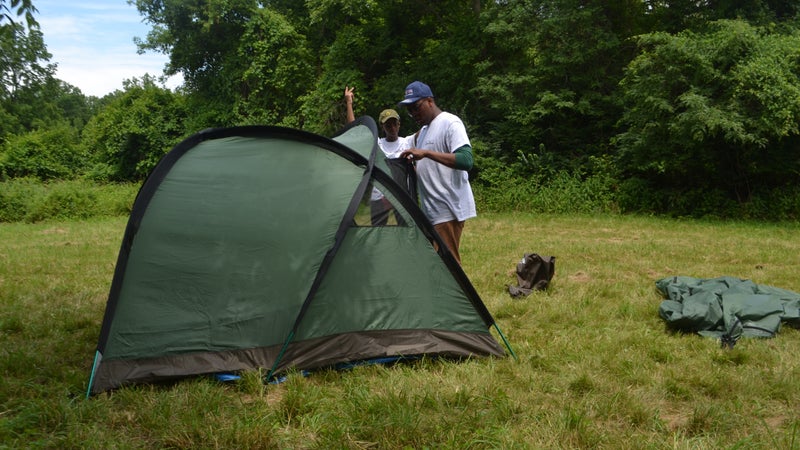 Part of the program is learning camping skills, like setting up a tent.