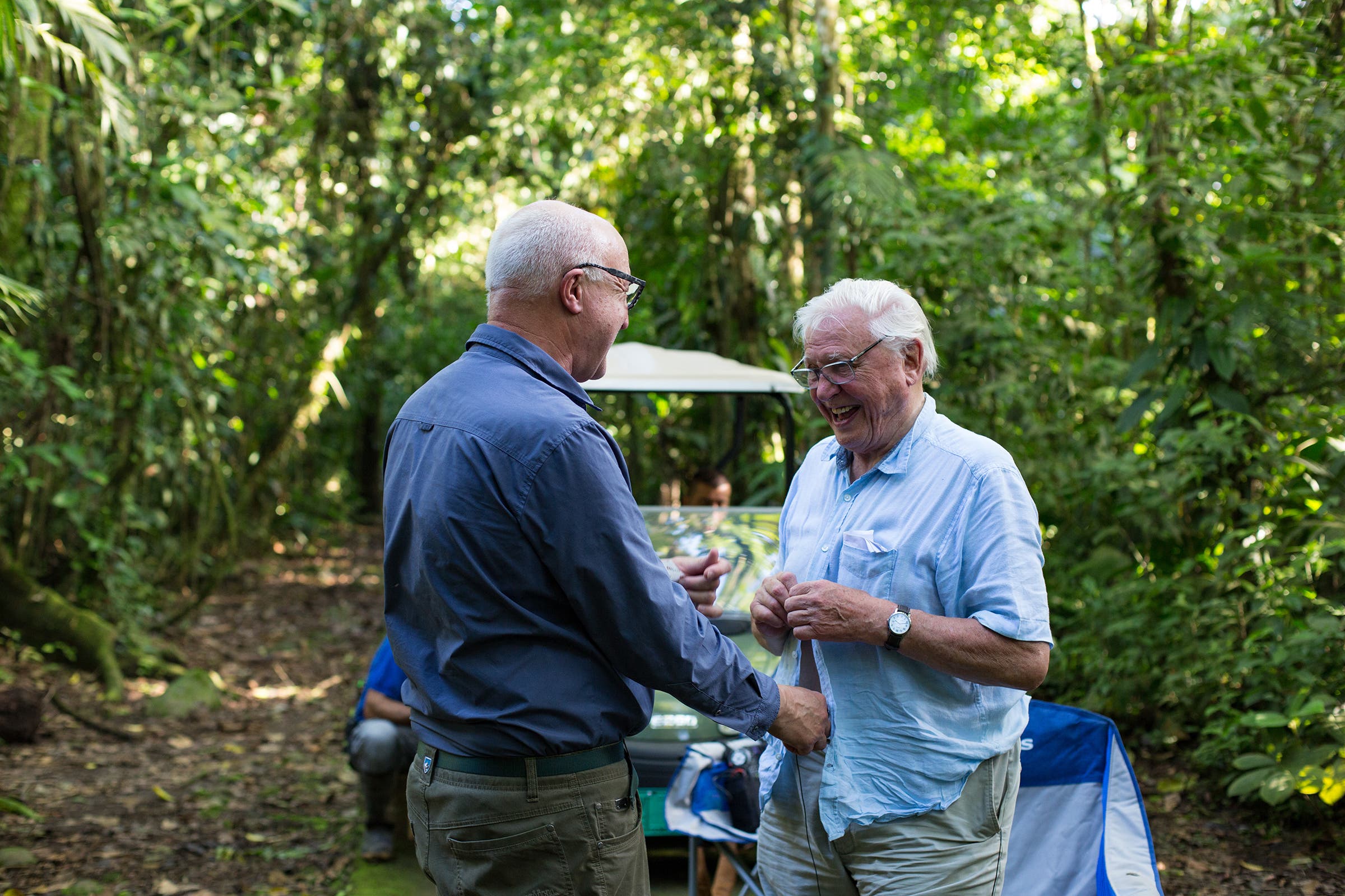 Chris Watson (left) putting a microphone on David Attenborough while filming in Costa Rica