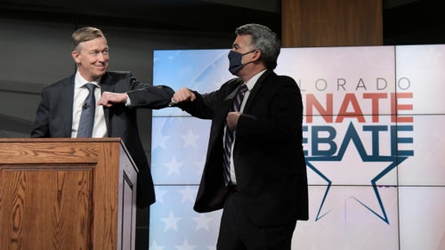 Republican senator Cory Gardner, right, and Democratic former Colorado governor John Hickenlooper elbow-bump after a debate on October 9, 2020.