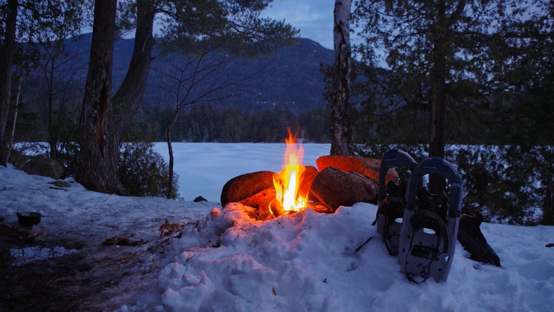 Winter Campfire on Copperas Pond with Snow Shoes in the Adirondack Mountains of Upstate New York.