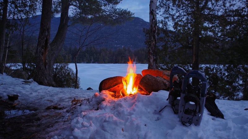 Winter Campfire on Copperas Pond with Snow Shoes in the Adirondack Mountains of Upstate New York.