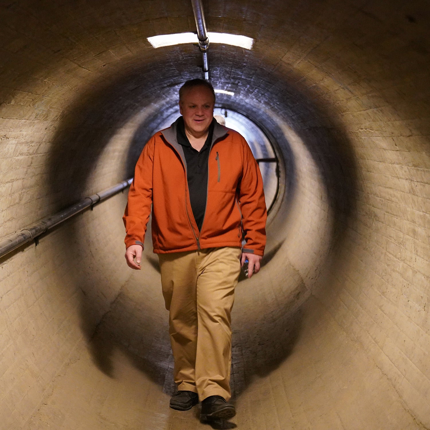 Secretary of the Interior, oil lobbyist David Bernhardt, walks through a tunnel.