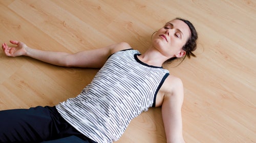 Woman lying on a wooden floor